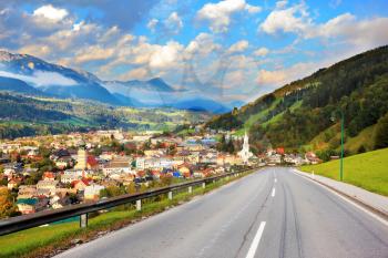 Gorgeous Austria. The road in the Alps. The picturesque small town is wonderfully illuminated by the sun