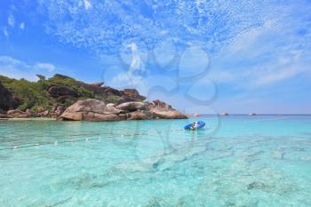 Moored in the bay inflatable boat. Exotic tropical Similan Islands. Clear azure ocean water