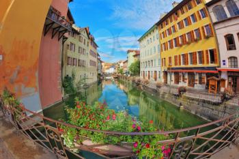 Charming old town of Annecy in Provence. Clear early in the morning. Bridge over the canal is decorated with flowers