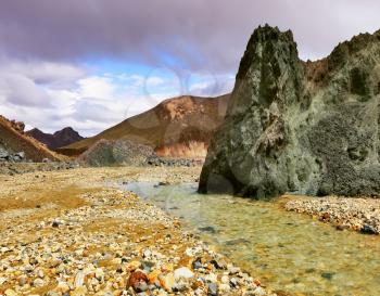 The green stone rock and stream in the gorge. National park Landmannalaugar in Iceland