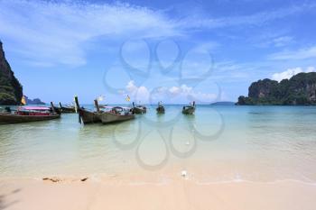  Picturesque native boats Longtail expect the first morning tourists. Magic beach on island.