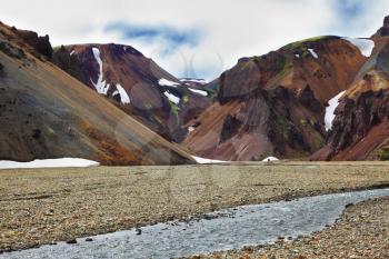 Magnificent colorful mountains. Reserve Landmannalaugar, Iceland. The route starts on a stream