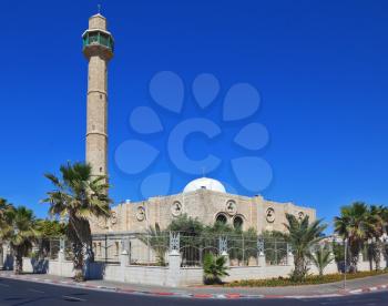 TEL AVIV, ISRAEL - MAY 2, 2014: Spring Tel Aviv promenade. Arab mosque and minaret against a bright blue sky