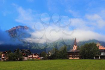Charming Austrian province. Picturesque houses in mountain alpine meadows