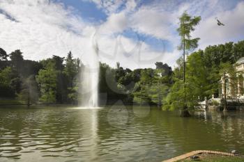 Colonnade, lake and fountain in Madrid park Buen-Retiro