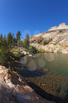Early clear autumn morning. Picturesque transparent lake in mountains Yosemite national park