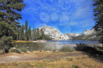 Gorgeous American nature. The majestic Lake Tioga in a hollow among the mountains famous Yosemite National Park
