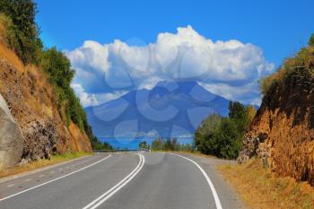 The road leads to the famous volcano Osorno. Top of the volcano cloud closed. Scenic highway in South America - Carretera Austral