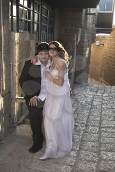 The beautiful, happy groom and the bride on prewedding walk street, ancient, narrow.
