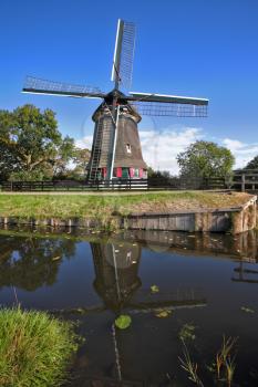 Ancient small village in Holland with windmills and the channel