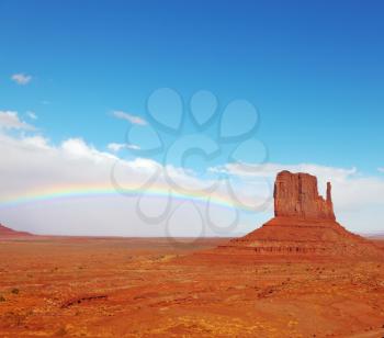 Rainbow in a red desert. Monument Valley in the autumn, after rain