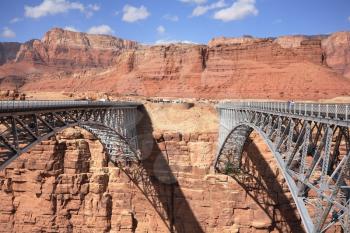 Thel bridge through the river Colorado in abrupt coast of desert from red sandstone
