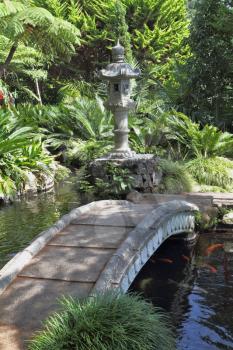 The park on the island of Madeira -  Monte Palace Tropical Garden. The a wonderful bridge over a pond with goldfish. 