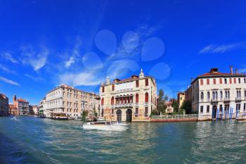 The famous Grand Canal in Venice. In the foreground is a graceful white yacht. Photo taken by lens Fisheye
