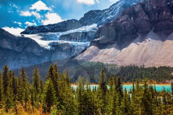  Canada, Rocky Mountains, Banff National Park. The Glacier Crowfoot over Bow River in bright striped mountains