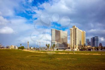 TEL AVIV, ISRAEL - JANUARY 1, 2016:  Windy and bright winter day on the sea coast. Skyscrapers on the embankment of Tel Aviv