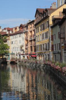 The ancient city in the south of France - Annecy. Homes are reflected in the smooth water channel