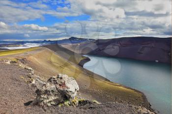  The blue lake in a crater of the cooled-down volcano. Coast of the lake are put from a red rhyolite. Iceland in July