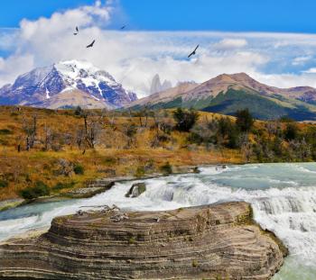 Scenic powerful and high-water waterfall Cascades Paine. National Park Torres del Paine in southern Chile