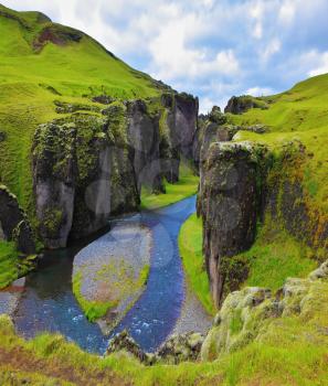 Fantastic country Iceland. The most picturesque canyon Fjadrargljufur and river flowing along the bottom of the canyon