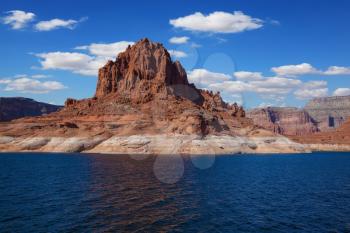 Scenic huge artificial pond Powell on the Colorado River, USA. The lake is surrounded by picturesque banks of  orange sandstone. Walk around the lake Powell at sunset