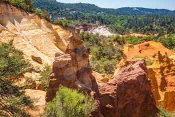 Picturesque orange and red hills. Reserve - quarry for ocher mining. Languedoc - Roussillon, Provence, France
