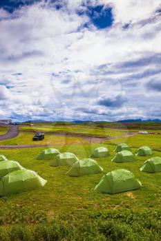 Scenic camp on a green meadow. Summer holidays in Iceland