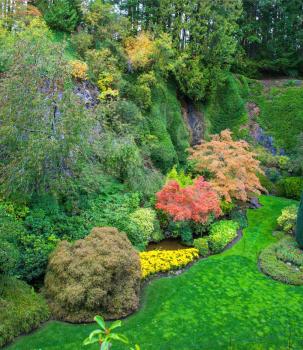 Butchart Gardens - beautiful gardens on Vancouver Island. Flower beds of colorful flowers and walking paths for tourists. The world-famous masterpiece of park architecture