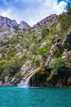  National park Merkantur, Provence, France. The picturesque azure waterfall on the side wall of canyon Verdon
