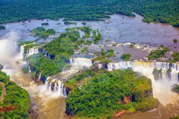 Waterfalls are located in the two national parks - Argentina and Brazil in the dense tropical forests. The famous Iguazu Falls on the Brazilian-Argentine border. Picture taken from a helicopter