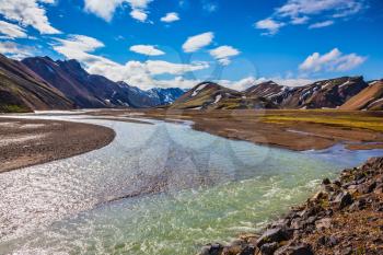 The picturesque valley in the national park Landmannalaugar, Iceland. Summer flood of meltwater flooded the road to a tourist camping