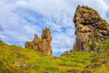 Magnificent Iceland. Northern sea coast. The picturesque ancient rocks covered with a green and yellow moss