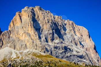 Indian summer in the Tyrol. Magnificent rock mountain on the picturesque Sella Pass in the Dolomites. The concept of extreme and ecological tourism