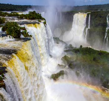 Iguazu Falls in South America, on the border of two countries: Brazil and Argentina. World of falling water. Concept of active and extreme tourism