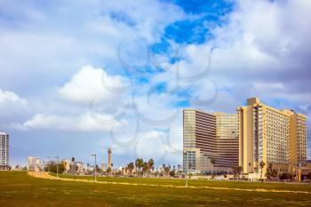 TEL AVIV, ISRAEL - JANUARY 1, 2016: Skyscrapers on the waterfront in Tel Aviv. Windy and bright winter day at the seaside