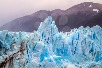 The glacier Perito Moreno. On the surface of the glacier formed Calgaspors - penitent firn. Patagonian province of Santa Cruz, Lake Argentino. The concept of exotic and extreme tourism