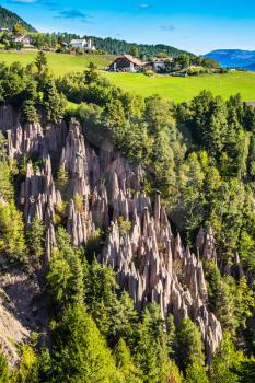 The charming small village in the Dolomites. Wonderful Tirol, Italy. Renon's earth pillars at sunrise. The concept of ecological tourism