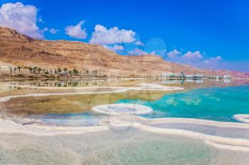  The concept of ecological and medical tourism. Reduced water in the salty Dead Sea, Israel. The evaporated salt has developed into fantastic patterns