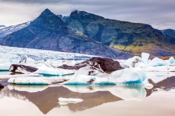 The glacier in Iceland - Vatnajokull  in the summer. Huge ice floes have broken away from a glacier and drift towards the ocean. The concept of northern extreme tourism
