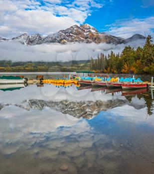 Pyramid Lake, Jasper National Park. Concept of active vacation and tourism.  Boat station with boats waiting for tourists