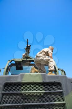Royalty Free Photo of a Soldier on an Armoured Vehicle