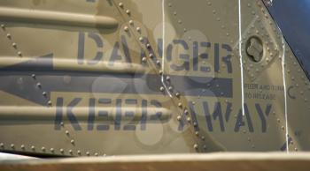 Royalty Free Photo of Danger Keep Away on the Side of an Army Vehicle