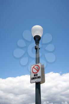 Royalty Free Photo of a No Smoking Sign on a Streetlight
