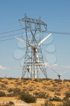 Royalty Free Photo of a Wind Turbine Beside Hydro Lines