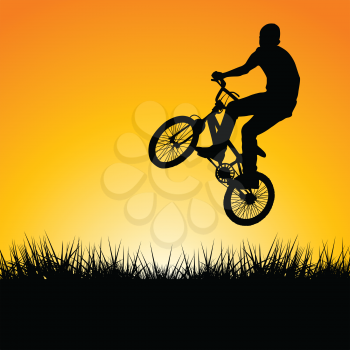 Silhouette of a biker jumping in the sunset