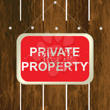 PRIVATE PROPERTY sign hanging on a wooden fence