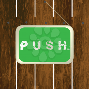 Push sign hanging on a wooden fence