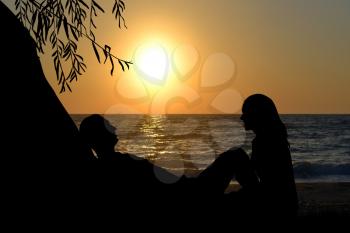 Romantic couple near the sea at sunrise