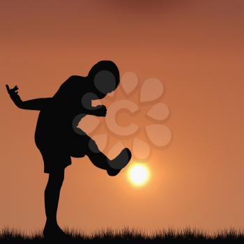 Silhouette of boy playing football with the sun