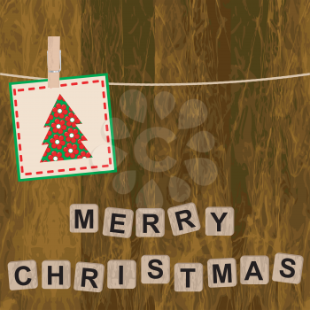 Christmas card with wooden blocks on wooden background